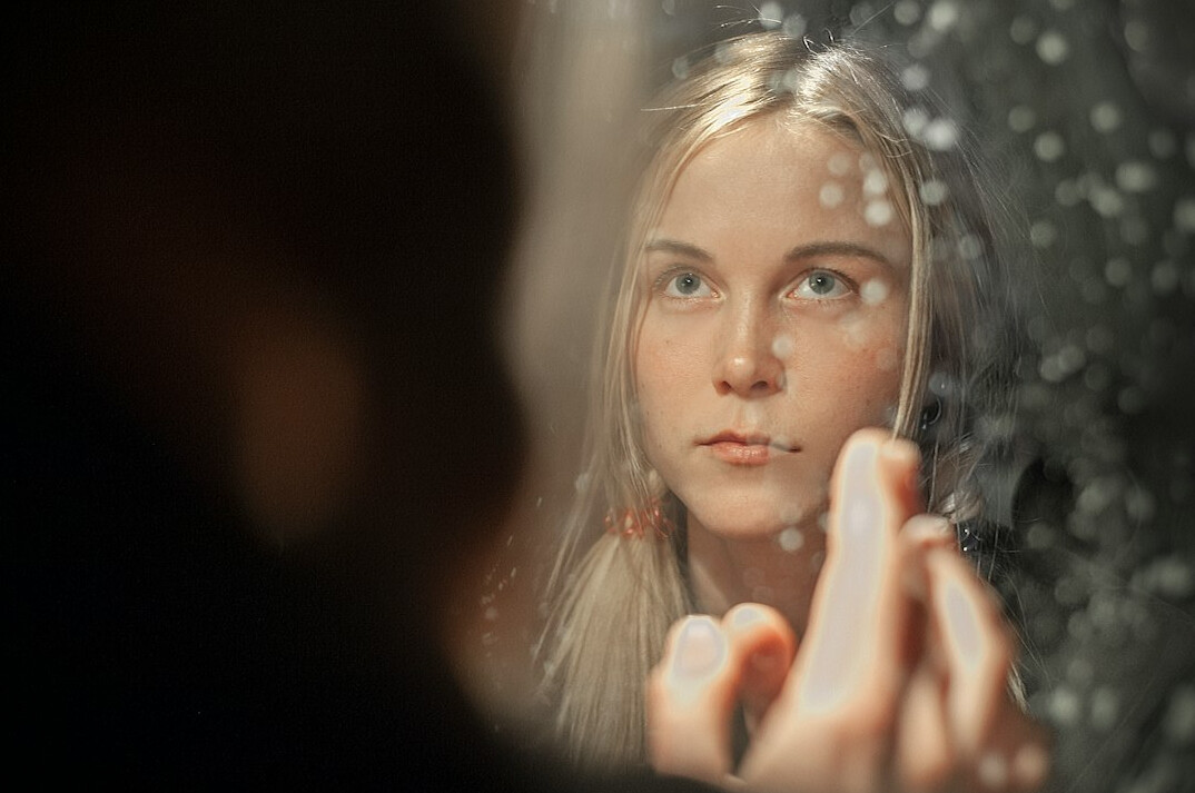 person reflecting in mirror